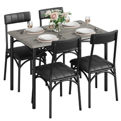 Rectangular dining table with dark wood-look top and four black cushioned chairs