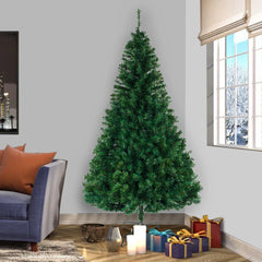 Artificial Christmas tree with full, conical green branches and metal base stand
