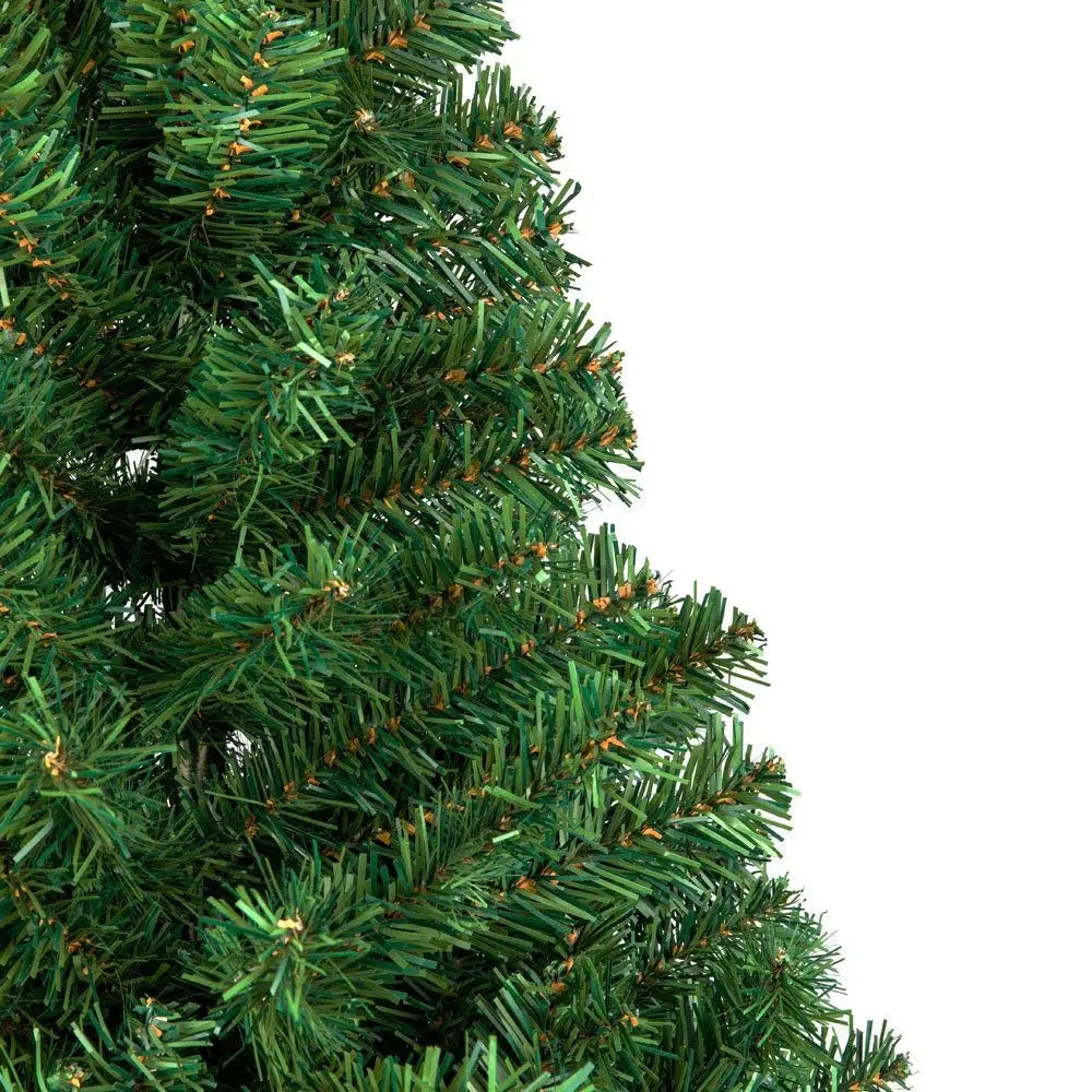 Close-up of green artificial Christmas tree branches with realistic PVC needle tips