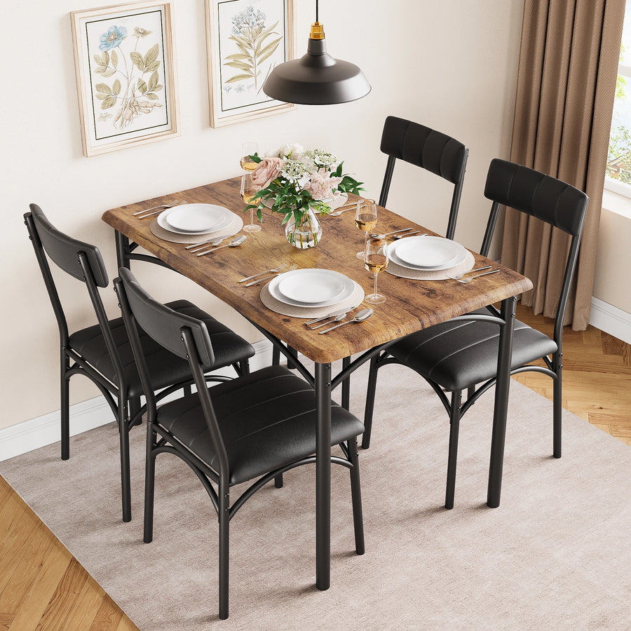Rectangular dining table with dark wood-look top and four black upholstered armchairs