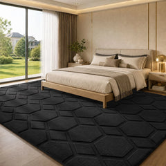 Black geometric area rug with embossed hexagon pattern, low-pile textured surface