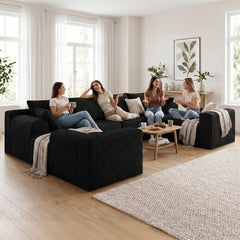 Black corduroy modular corner sofa with deep seats and scatter cushions, U-shaped layout