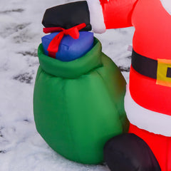 Close-up inflatable Santa with green gift sack and blue-red present, red suit trim