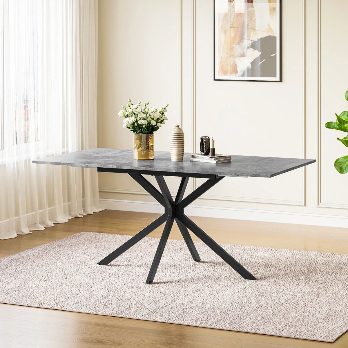 Rectangular extendable dining table with dark tabletop and black X-style legs.
