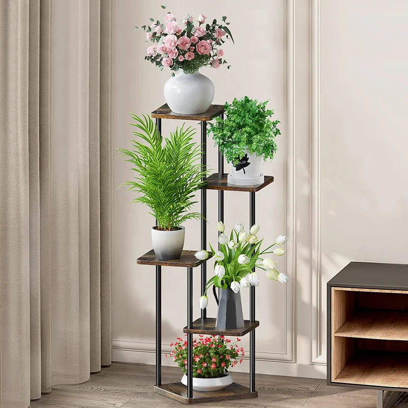 Multi-tier plant stand with wooden shelves, black metal frame, and white pots