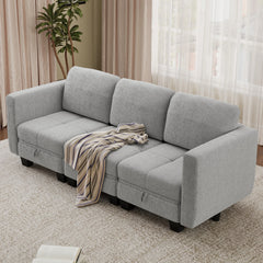 Light gray fabric sectional sofa with wide back cushions and ottoman chaise
