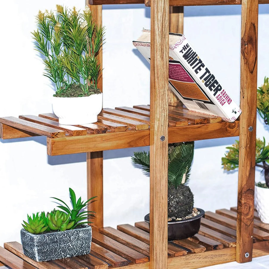 Wooden plant stand with open slatted shelves holding potted plants and decor