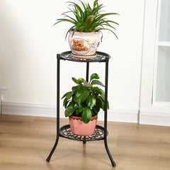 Black metal 2-tier plant pot rack with round shelves and decorative base, potted plants on top