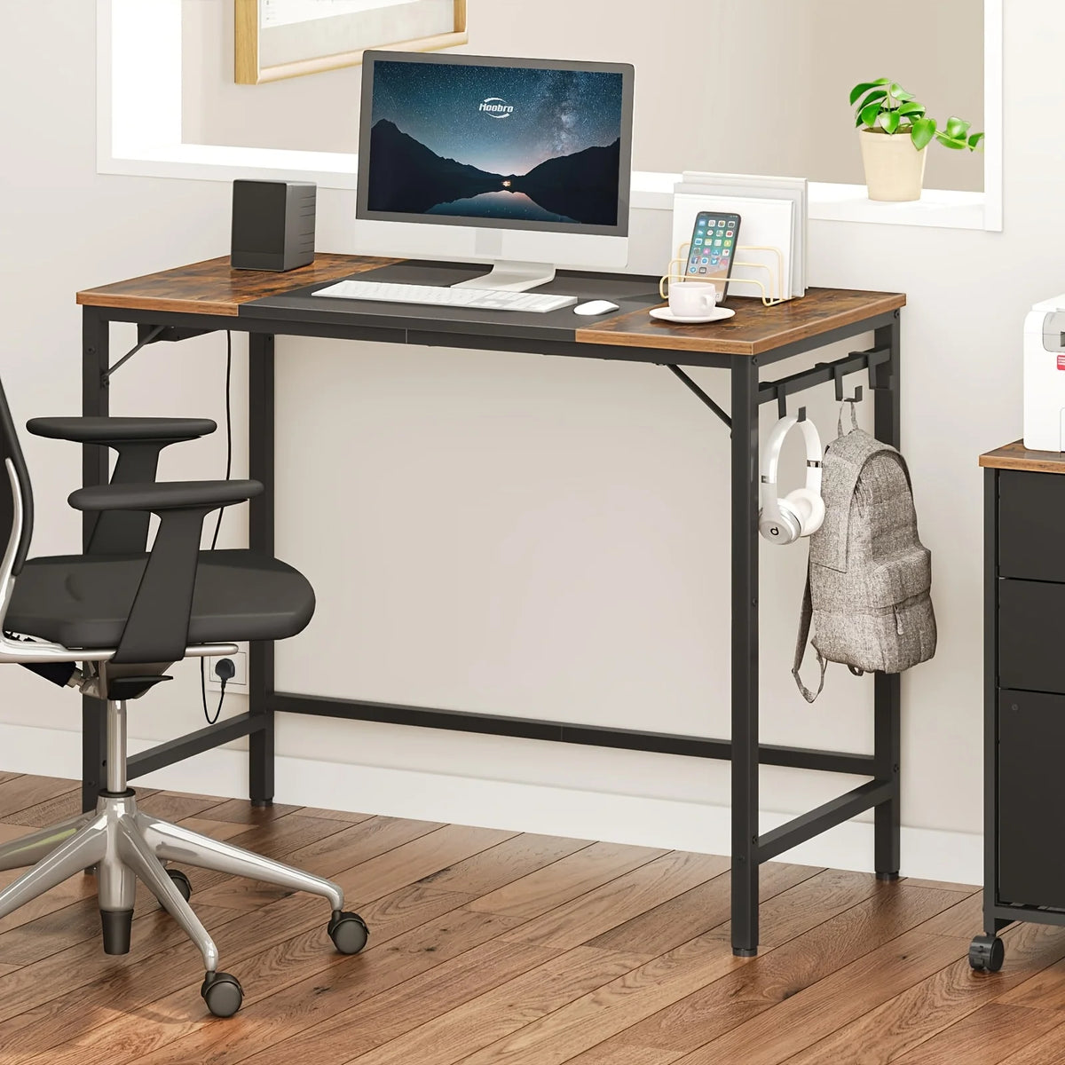 Brown and dark computer desk with monitor, keyboard, and side hooks for hanging items