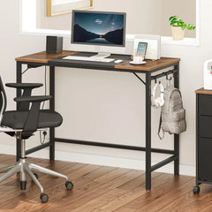 Brown and dark computer desk with monitor, keyboard, and side hooks for hanging items