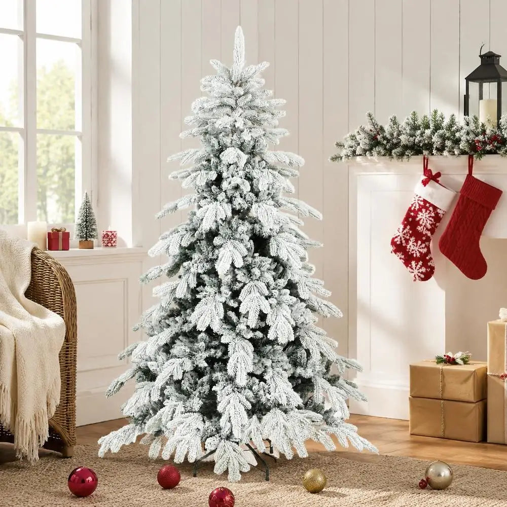Flocked artificial Christmas tree with snow-dusted branches and metal folding stand