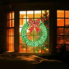 Green pre-lit metal Christmas wreath with red bow and warm LED lights