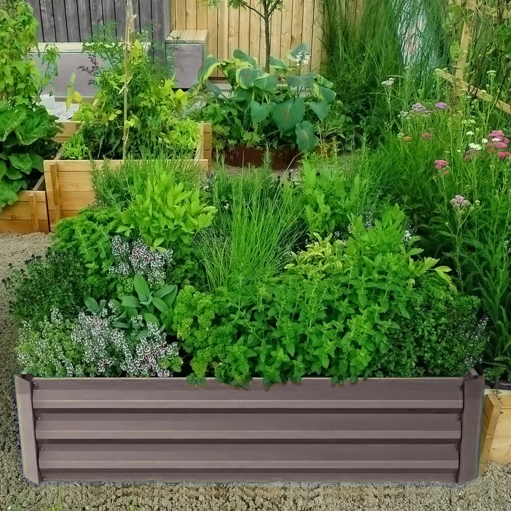 Outdoor raised bed planter with dark gray slatted frame, filled with leafy greens.