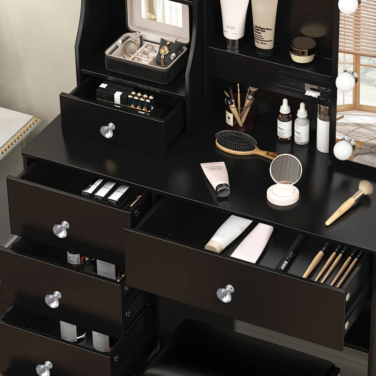 Black vanity set with open drawers and countertop compartments for makeup storage.