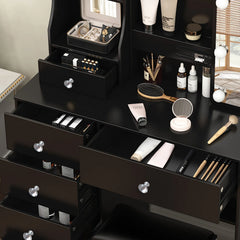 Black vanity set with open drawers and countertop compartments for makeup storage.