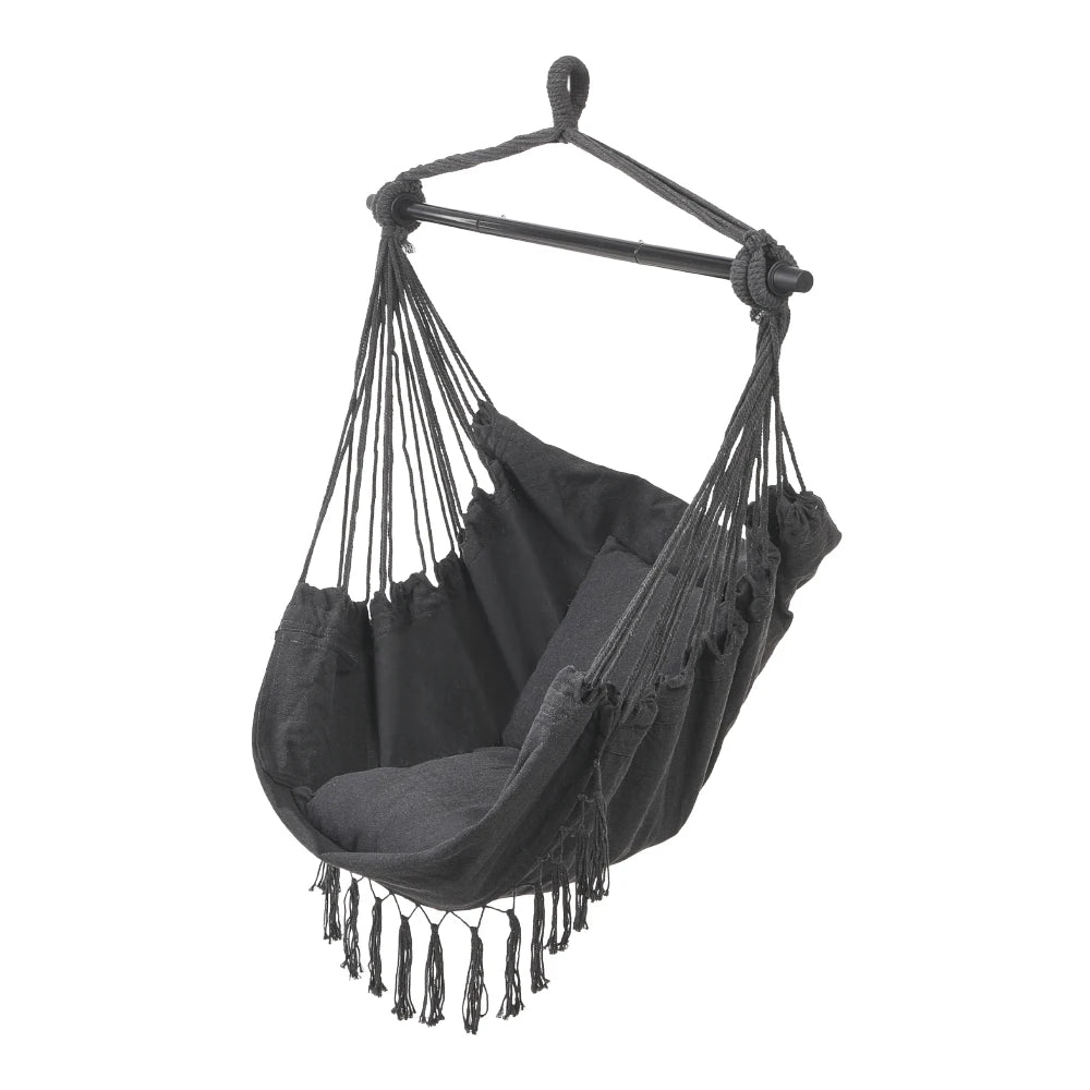 Dark gray canvas hanging swing chair with fringe tassels and rope spreader bars.