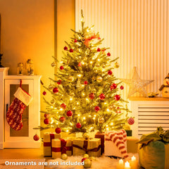 Artificial Christmas tree with warm LED lights and red and gold ball ornaments