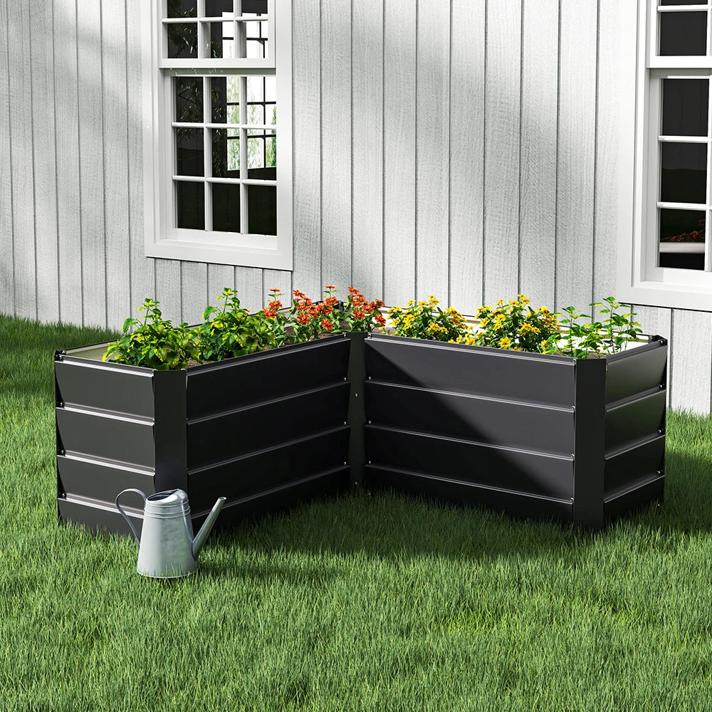 Charcoal black L-shaped metal raised garden bed with layered side panels and open top