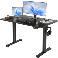 Black electric standing desk with dual monitor setup and cable-friendly design