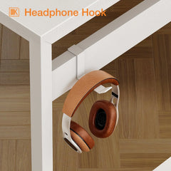 White desk corner with brown headphone hook under tabletop, accessory storage.