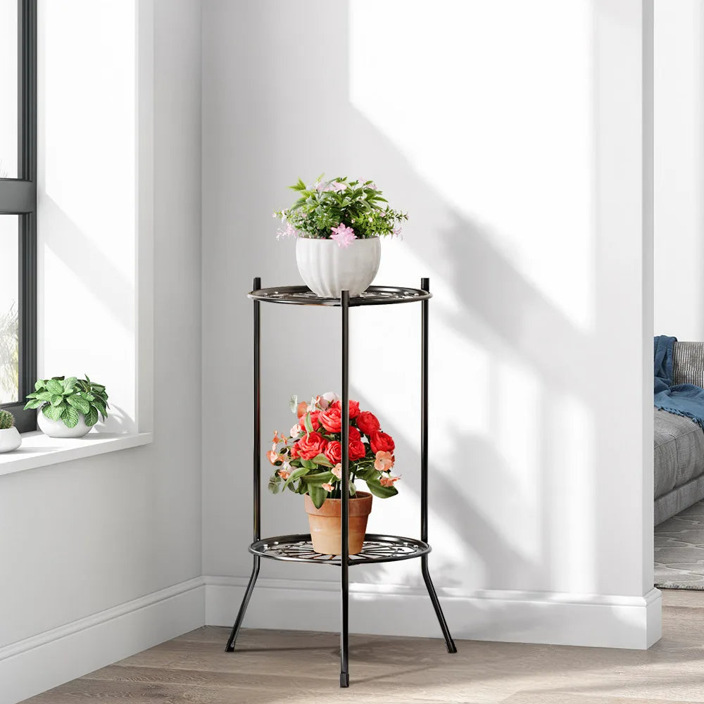 Black metal 2-tier plant pot stand with round top and bottom shelves, scroll base