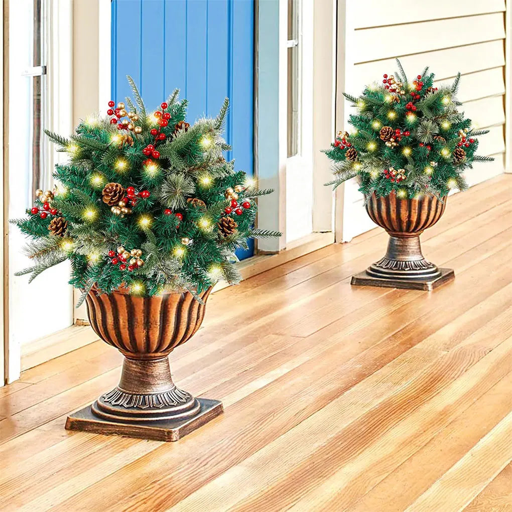 Outdoor Christmas tree with lights, green pine tips, red and gold ornaments, urn stand
