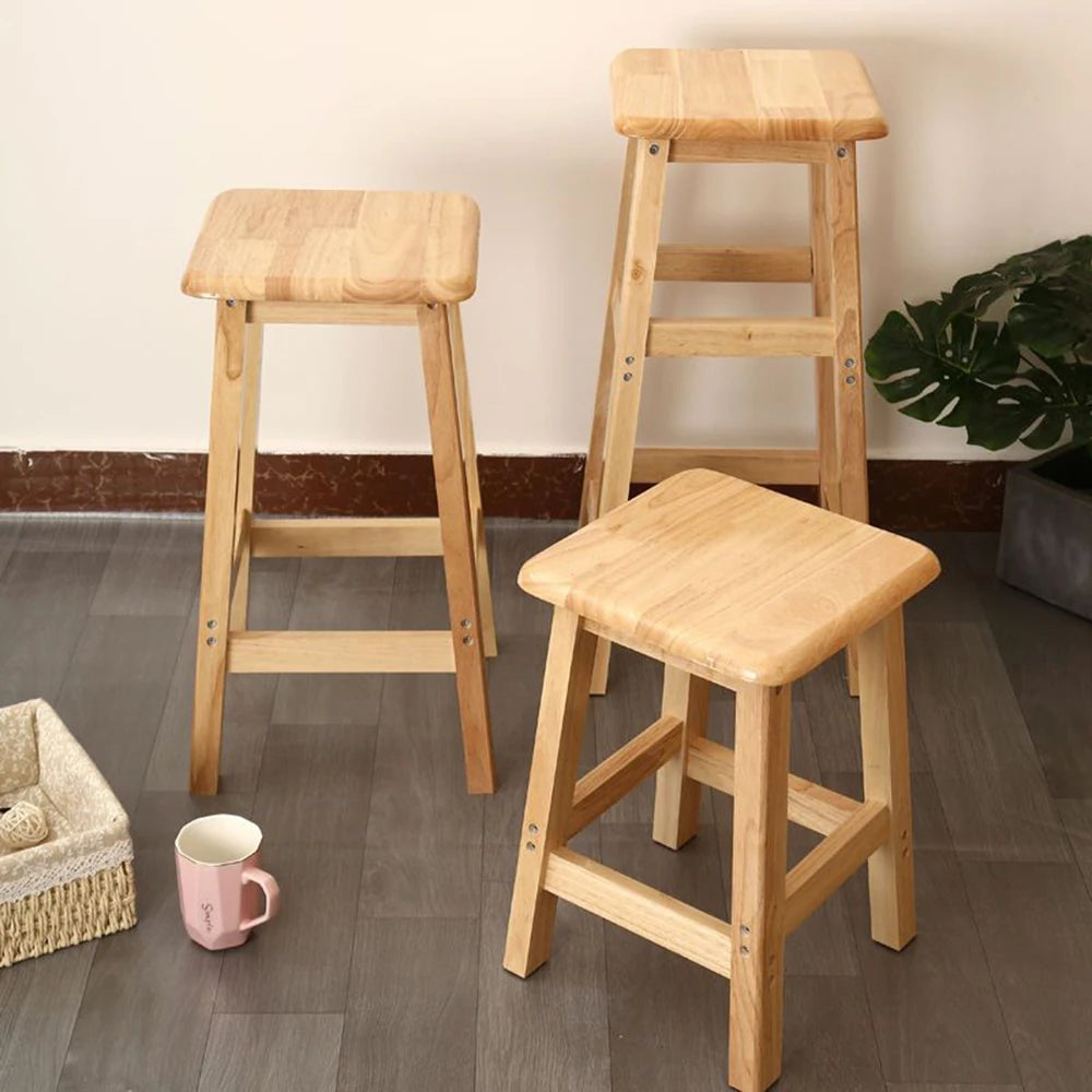 Natural wood bar stools with square seats and ladder-style support frames