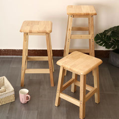 Natural wood bar stools with square seats and ladder-style support frames