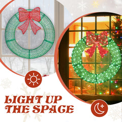 Green lighted metal wreath with red bow, shown on a door window