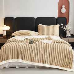 Beige weighted fleece blanket with dense ribbed texture and off-white trim