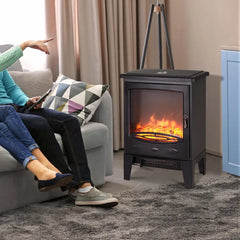 Black freestanding electric fireplace with glowing flame window and front heat vent grille.