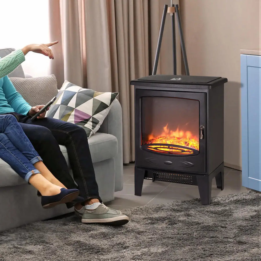 Black freestanding electric fireplace with glowing flame window and front heat vent grille.