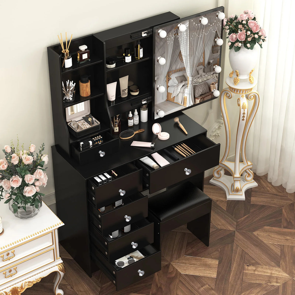 Black vanity set with LED sliding mirror, stacked drawers, and upholstered stool.