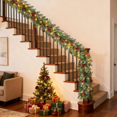 Handmade Christmas vine garland with pine greenery and warm lights on stair railing