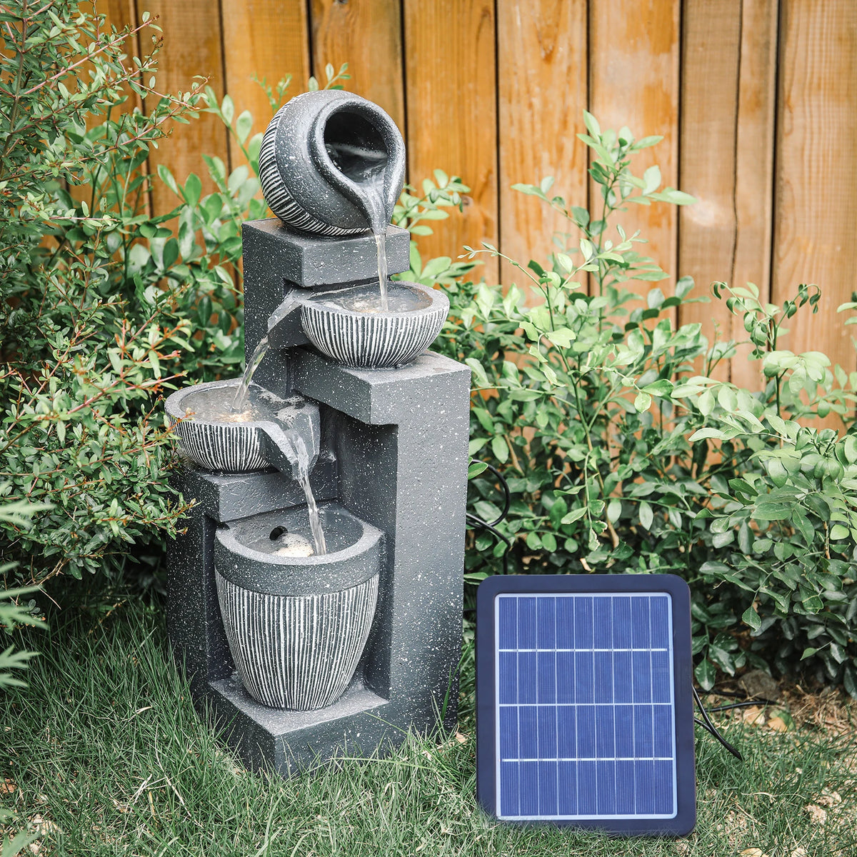 Solar outdoor rockery fountain with stacked gray basins, water flow, and solar panel